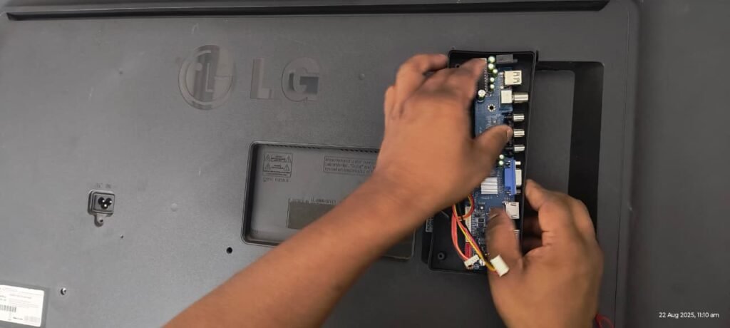  A technician checking the HDMI port or motherboard of an LG LED TV repair in Vizag 